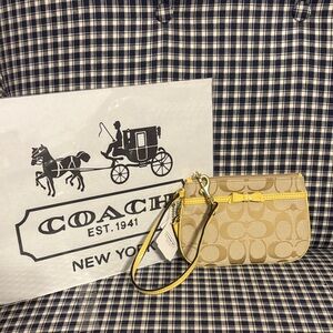 Coach Beige Wristlet with signature pattern  with Yellow Bow trim
